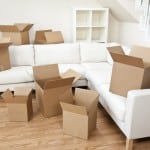 Empty room full of cardboard boxes for moving into a new home.