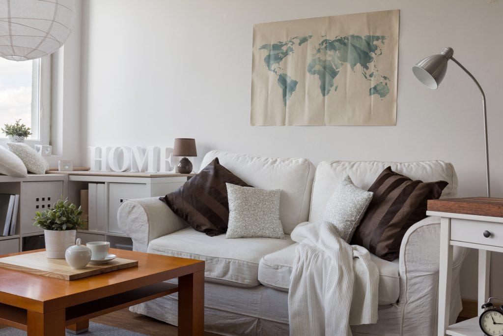 Image of comfortable white double sofa in day room